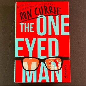 🟢 The One Eyed Man: A Novel by Ron Currie | Satirical Fiction | Hardcover Book